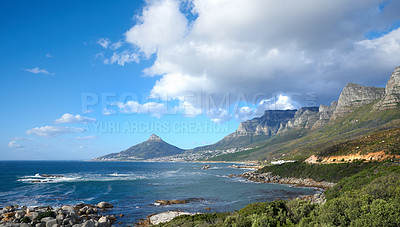 Buy stock photo A beautiful sea landscape near a mountain with lush green plants growing outdoors in nature. Peaceful and scenic view of the ocean or beach with copy space on a summer afternoon