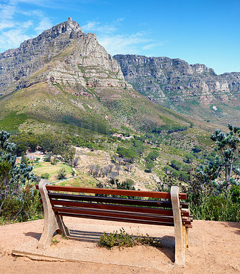 Buy stock photo Seating bench in a relaxing mountain range in a botanical garden. Table Mountain National park in Cape Town, South Africa with blue sky and local seating to enjoy calm and zen view of mother nature