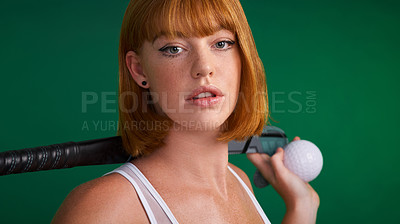 Buy stock photo Cropped shot of an attractive young sportswoman standing and posing with hockey equipment against a green studio background