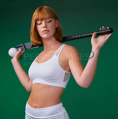 Buy stock photo Hockey, stick and woman in studio for sport, workout challenge and training for game tournament. Female athlete, redhead and equipment in green background for practice, competition or fitness contest