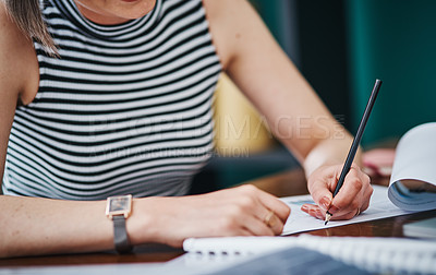 Buy stock photo Cropped shot of an unrecognizable businesswoman working on paperwork in her office