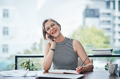 Buy stock photo Shot of a businesswoman making notes while talking on her cellphone