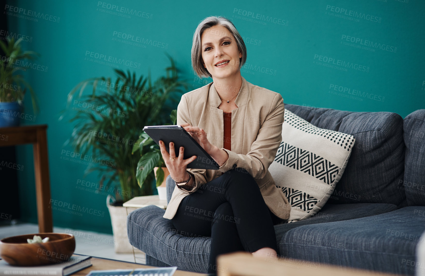 Buy stock photo Portrait, sofa and tablet with business woman in home office for remote work or research. App, planning and smile with happy mature employee reading information in living room for startup company