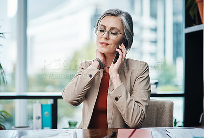 Buy stock photo Cropped shot of an attractive mature businesswoman sitting and suffering from a sore neck while in her home office