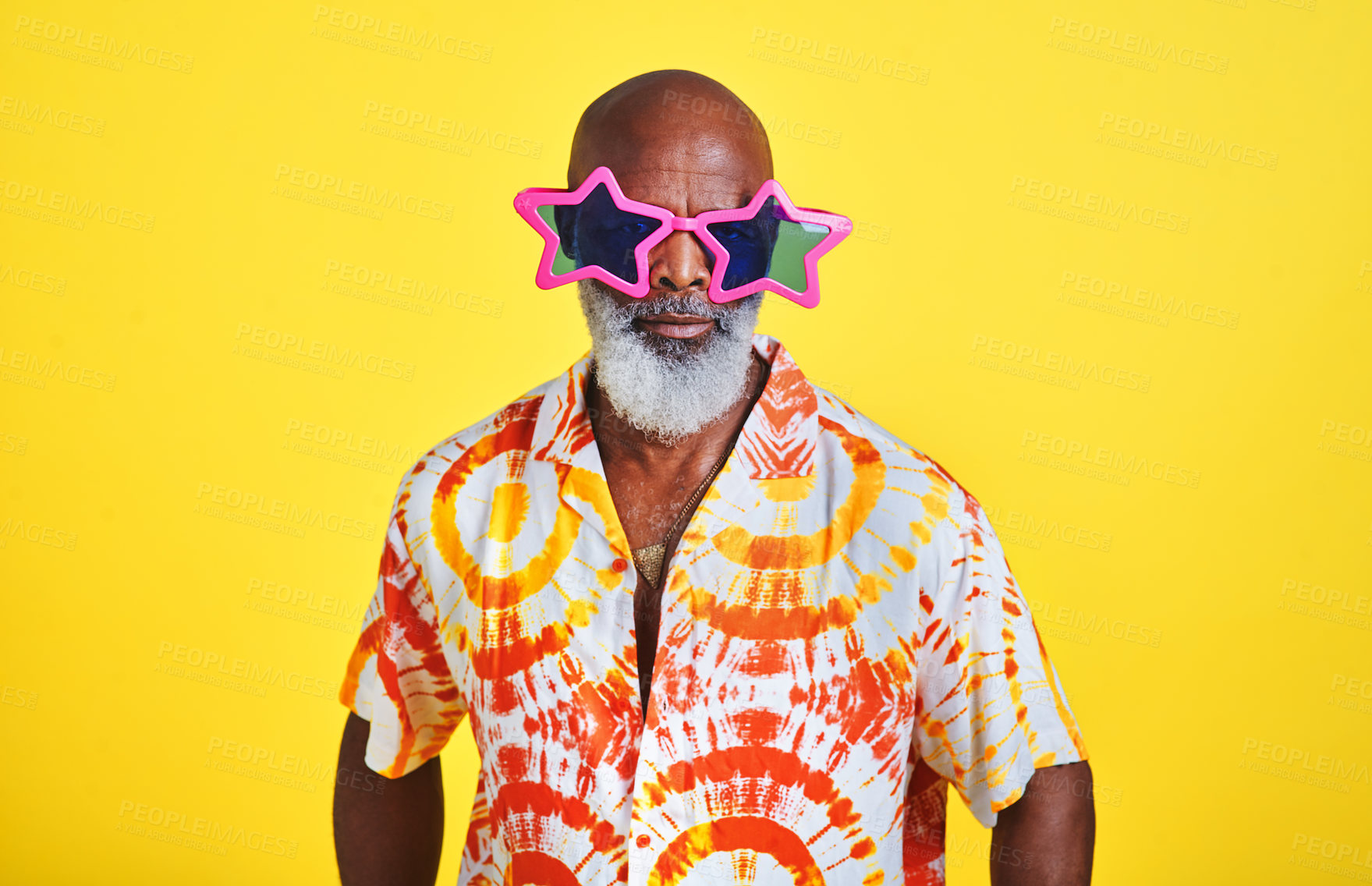 Buy stock photo Portrait of a funky and stylish senior man wearing sunglasses posing in studio against a yellow background