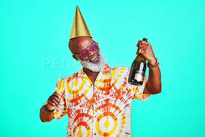 Buy stock photo Happy senior, black man or champagne with celebration for party, event or festive season in studio on a blue background. Mature African, male person or model with smile, wine or alcohol for good time