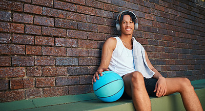 Buy stock photo Portrait of a sporty young man taking a break after a game of basketball