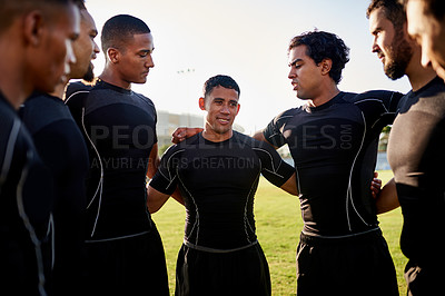 Buy stock photo Cropped shot of a diverse group of sportsmen standing together before playing rugby during the day