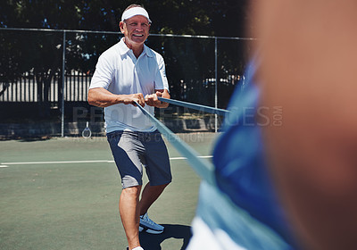 Buy stock photo Cropped shot of two handsome sportsmen using resistant bands during a tennis training session during the day
