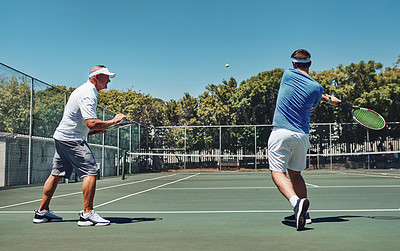 Buy stock photo Full length shot of a handsome mature sportsman coaching a fellow team-mate during a tennis training session