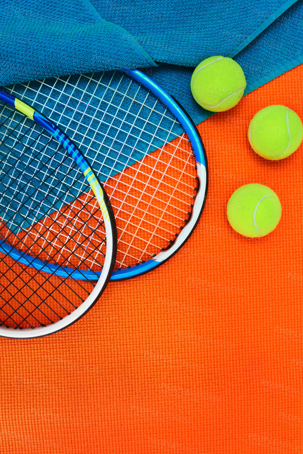 Buy stock photo High angle shot of tennis essentials placed on top of an orange background inside of a studio