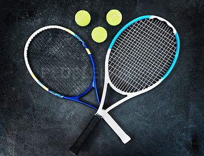 Buy stock photo High angle shot of tennis essentials placed on top of a dark background inside of a studio