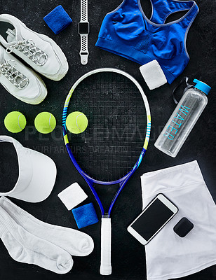Buy stock photo High angle shot of tennis essentials placed on top of a dark background inside of a studio