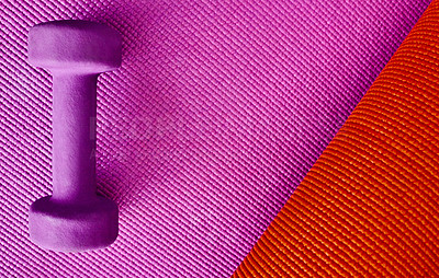 Buy stock photo High angle shot of a single lightweight dumbbell placed on top of a colourful background inside of a studio