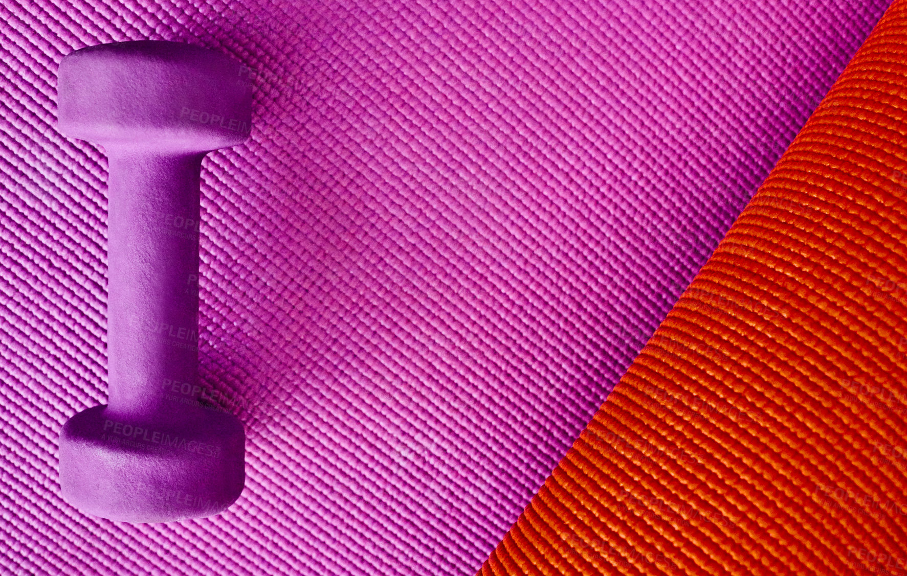 Buy stock photo High angle shot of a single lightweight dumbbell placed on top of a colourful background inside of a studio