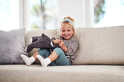 Buy stock photo Girl, sofa and bunny toy in portrait for play, care and excited with doll, morning and relax in family home. Kid, rabbit and plush animal on couch, game or happy with development in lounge in Germany