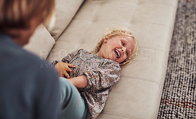 Buy stock photo Girl, mother and tickle for bonding, development and childhood fun in living room with laugh on sofa. Female child, family and playful in house for growth, games and joy with support, love and care