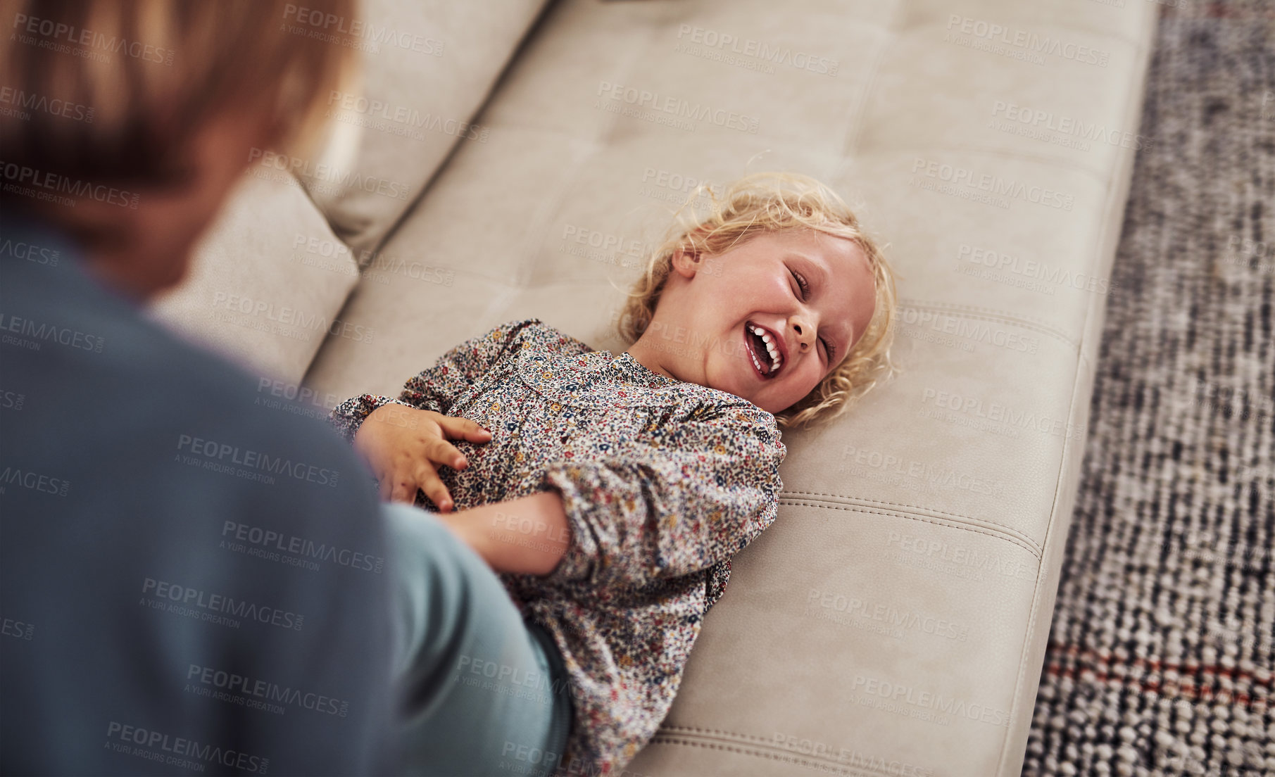 Buy stock photo Girl, mother and tickle for bonding, development and childhood fun in living room with laugh on sofa. Female child, family and playful in house for growth, games and joy with support, love and care