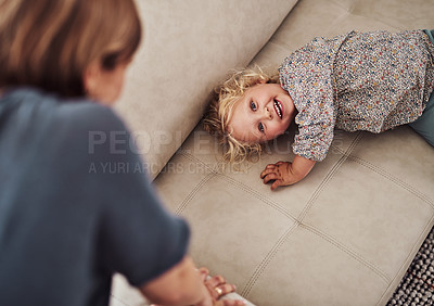 Buy stock photo Cropped portrait of an adorable little girl bonding with her mother during a day at home