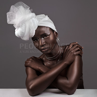 Buy stock photo Studio portrait of an attractive young woman posing in traditional African attire against a grey background