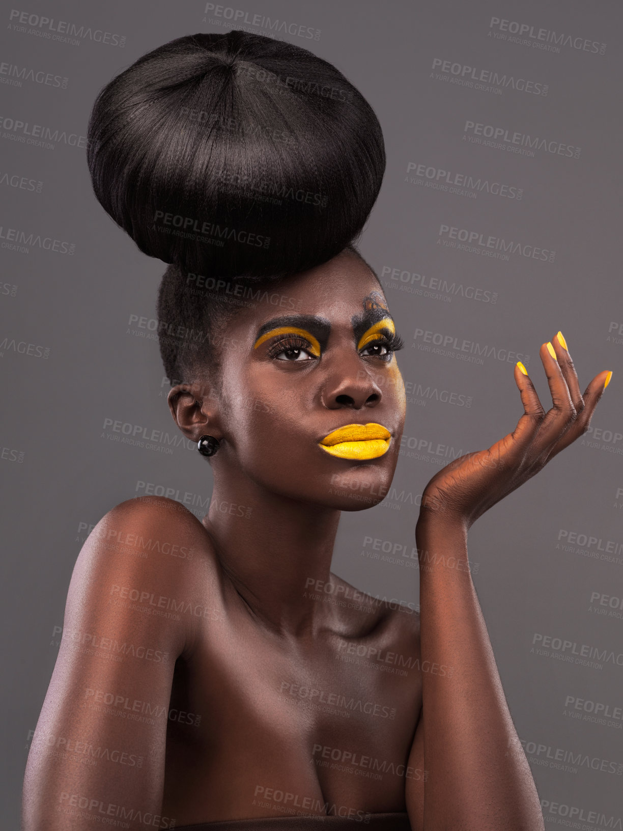 Buy stock photo African, person and studio face with makeup, beauty and creative yellow lipstick. Bold, woman and skin with confidence, dramatic hair and bun for glamour and trendy cosmetics on grey background