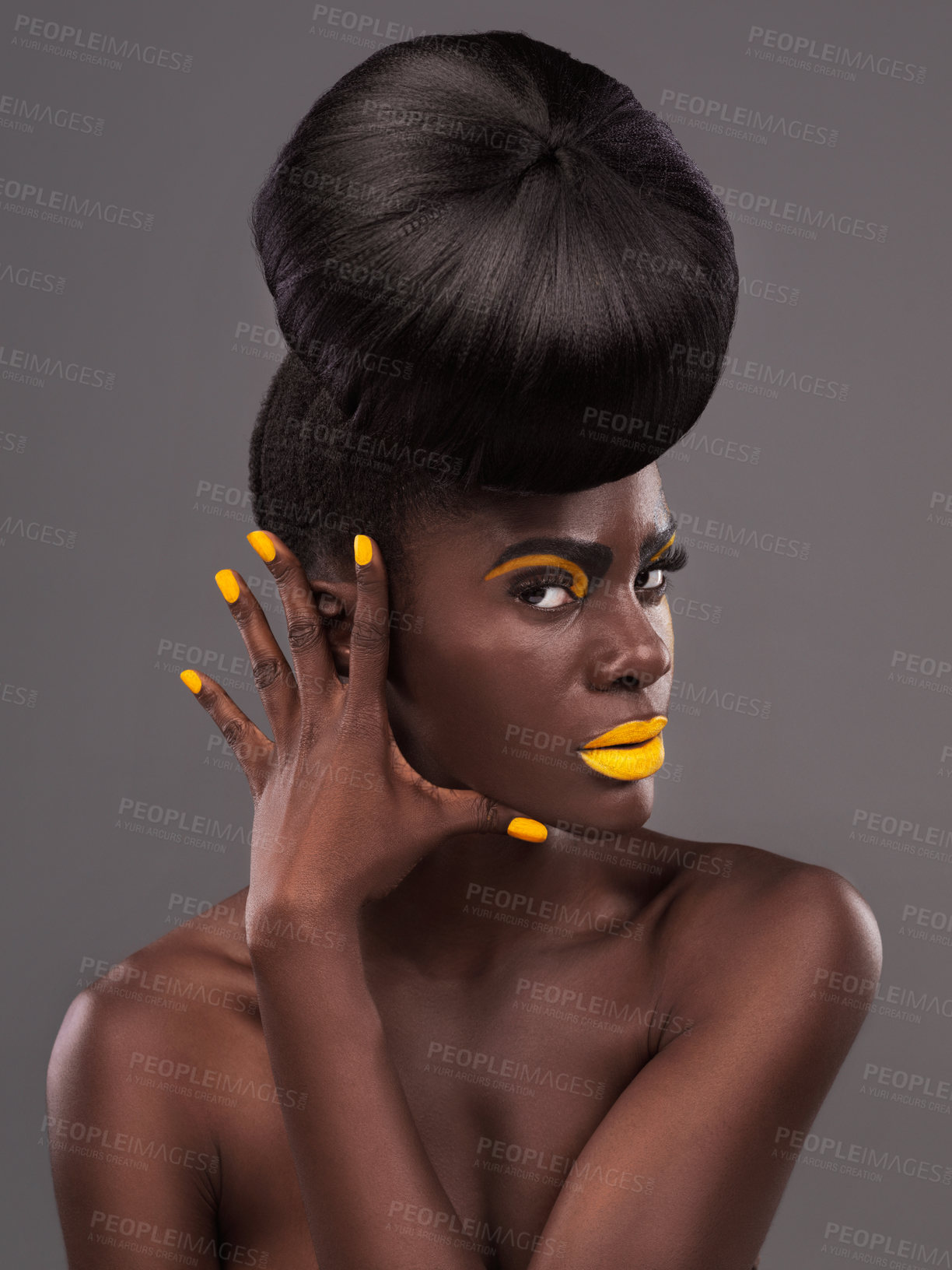 Buy stock photo African, model and studio colors for makeup, beauty and creative yellow lipstick. Bold, woman and skin with confidence, dramatic hair and bun for glamour or trendy cosmetics on grey studio background