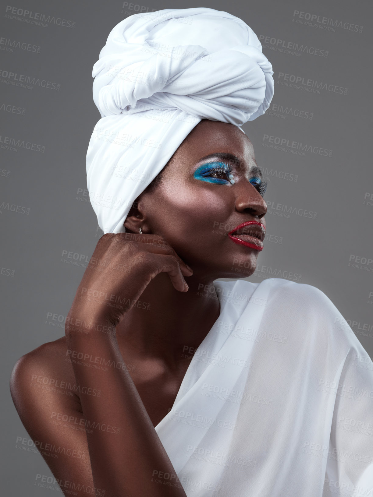 Buy stock photo Profile, wrap and black woman with makeup, fashion and confidence in studio on grey background. Face, beauty or proud African model with traditional turban, eyeshadow cosmetics or creative outfit