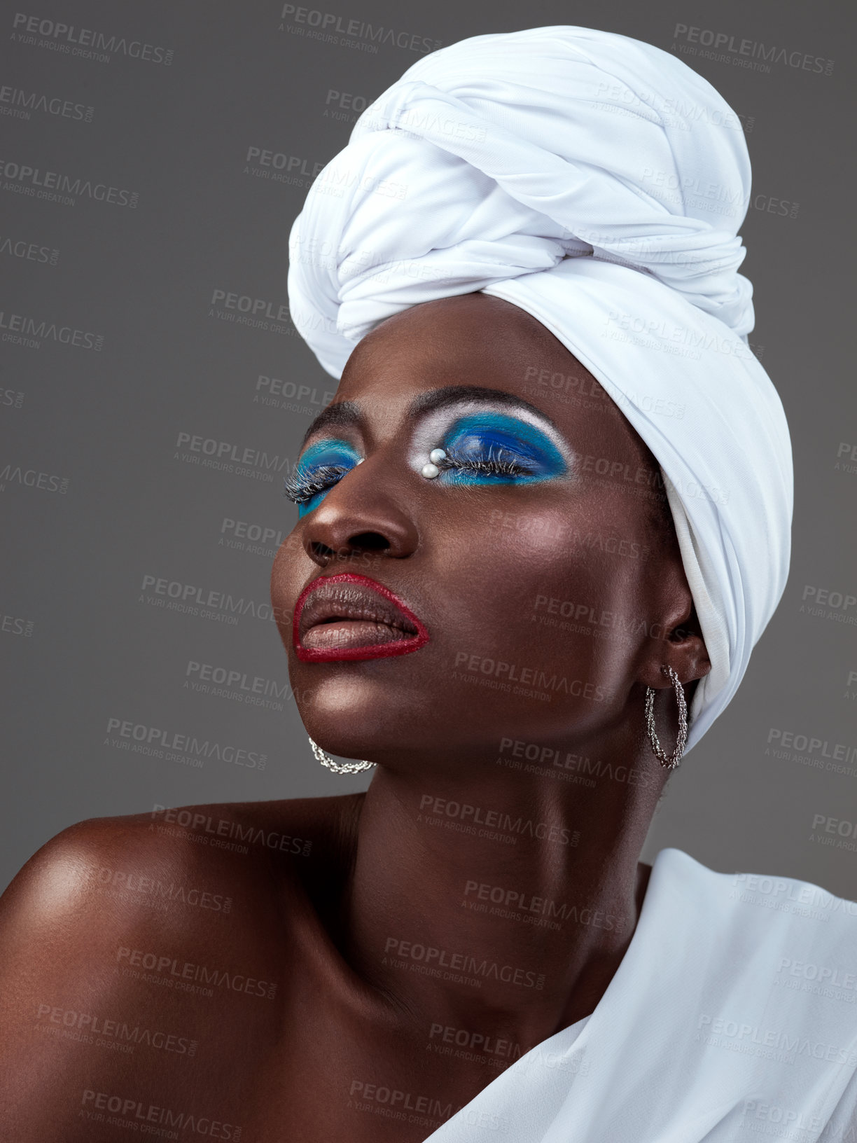 Buy stock photo African, art and creative woman with makeup and pride in beauty of indigenous culture. Studio, model and color face paint on skin with glow from cosmetics, skincare and traditional tribal style