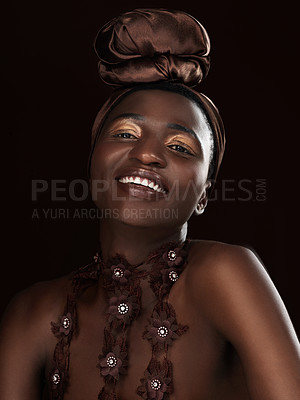 Buy stock photo Studio portrait of an attractive young woman posing in traditional African attire against a black background