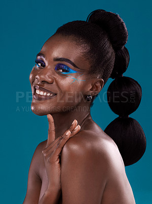Buy stock photo Portrait, smile and makeup with a model black woman in studio on a blue background for hair or cosmetics. Face, happy and fashion with an attractive young female person posing to promote beauty