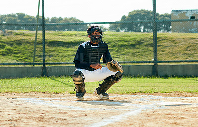 Buy stock photo Full length shot of a handsome young baseball player smiling while waiting to catch a ball during a game on the field