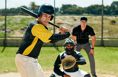 Buy stock photo Cropped shot of a handsome young baseball player preparing to bat a ball during a game on the field