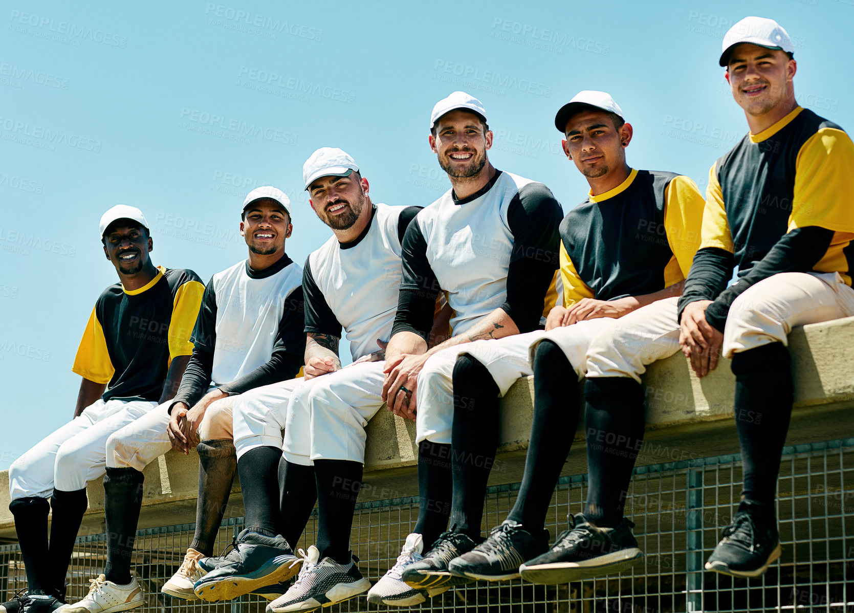 Buy stock photo Cropped portrait of a team of handsome young baseball players sitting near a baseball field