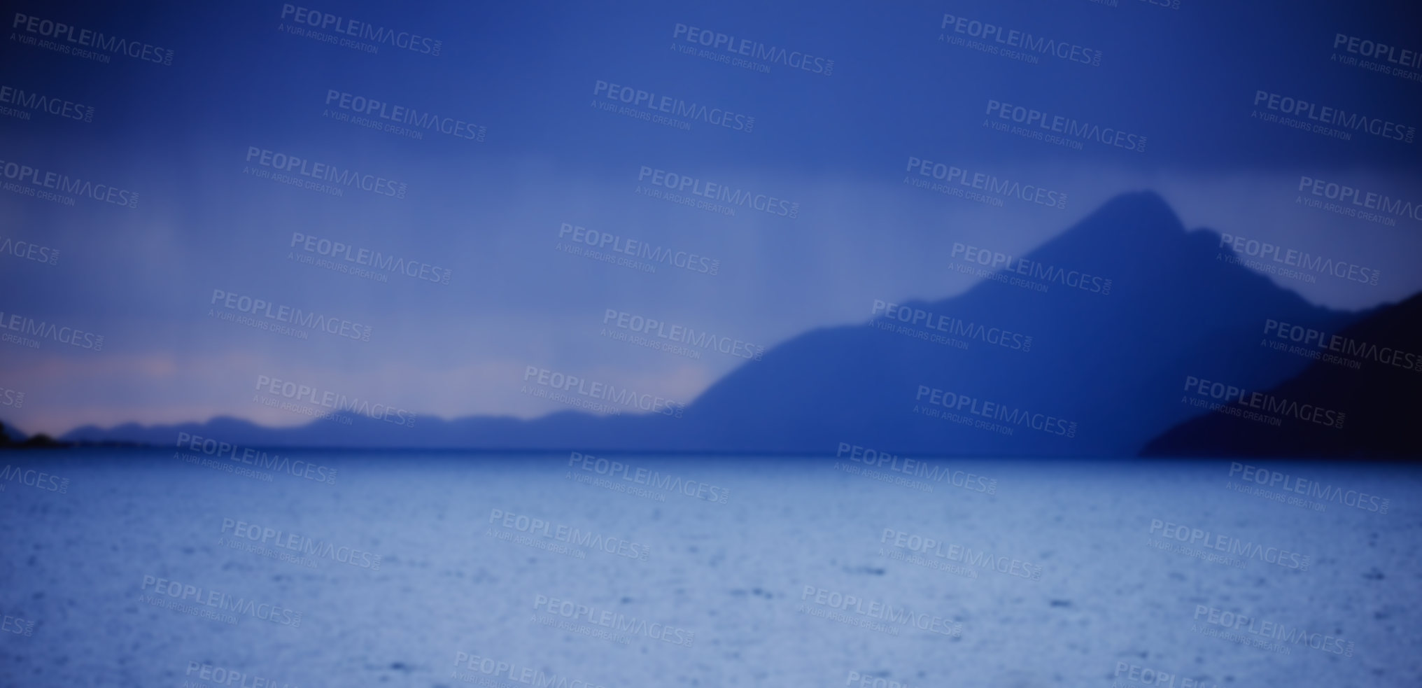 Buy stock photo Peaceful and scenic coastal bay at midnight. Beautiful landscape of a mountain near the sea in the evening with copy space. Scenic view of the ocean with dark blue sky during the night and copyspace