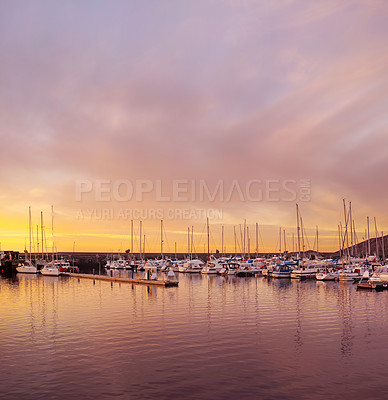 Buy stock photo Scenic view of private yachts docked in water harbor at sunset in Bodo, Norway. Nautical transport vessels and boats in a dockyard in the morning at dawn before sailing on the ocean, sea or lake