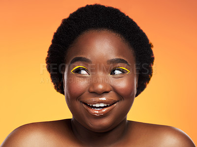 Buy stock photo Studio shot of a beautiful young woman looking thoughtful against an orange background
