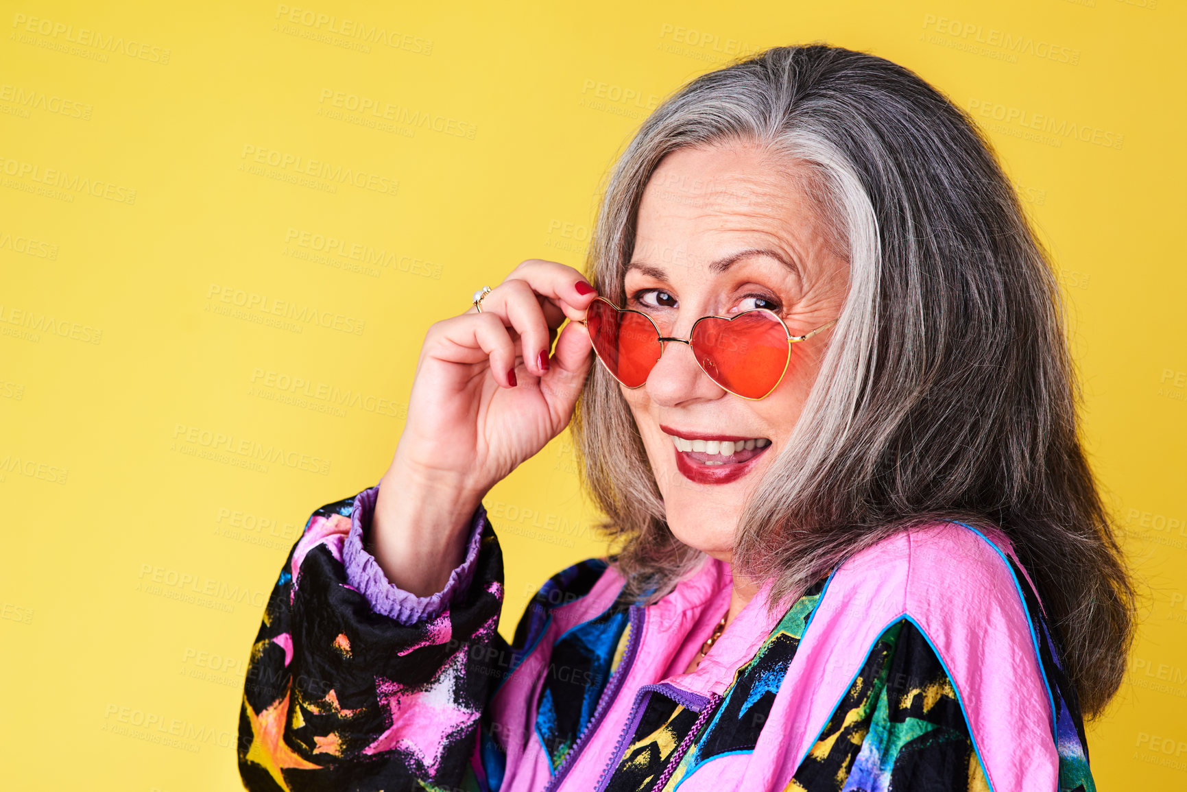 Buy stock photo Portrait of a confident and stylish senior woman wearing sunglasses posing against a yellow background