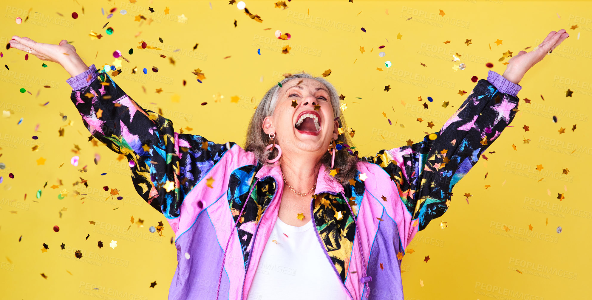 Buy stock photo Cropped shot of a cheerful and stylish senior woman celebrating with confetti falling over her against a yellow background