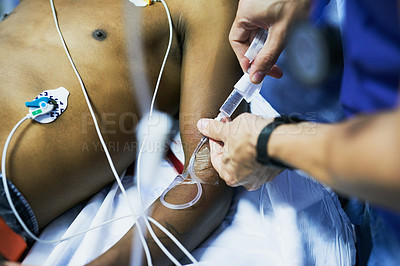 Buy stock photo Cropped shot of a doctor inserting an iv drip into a patient’s arm in an emergency room