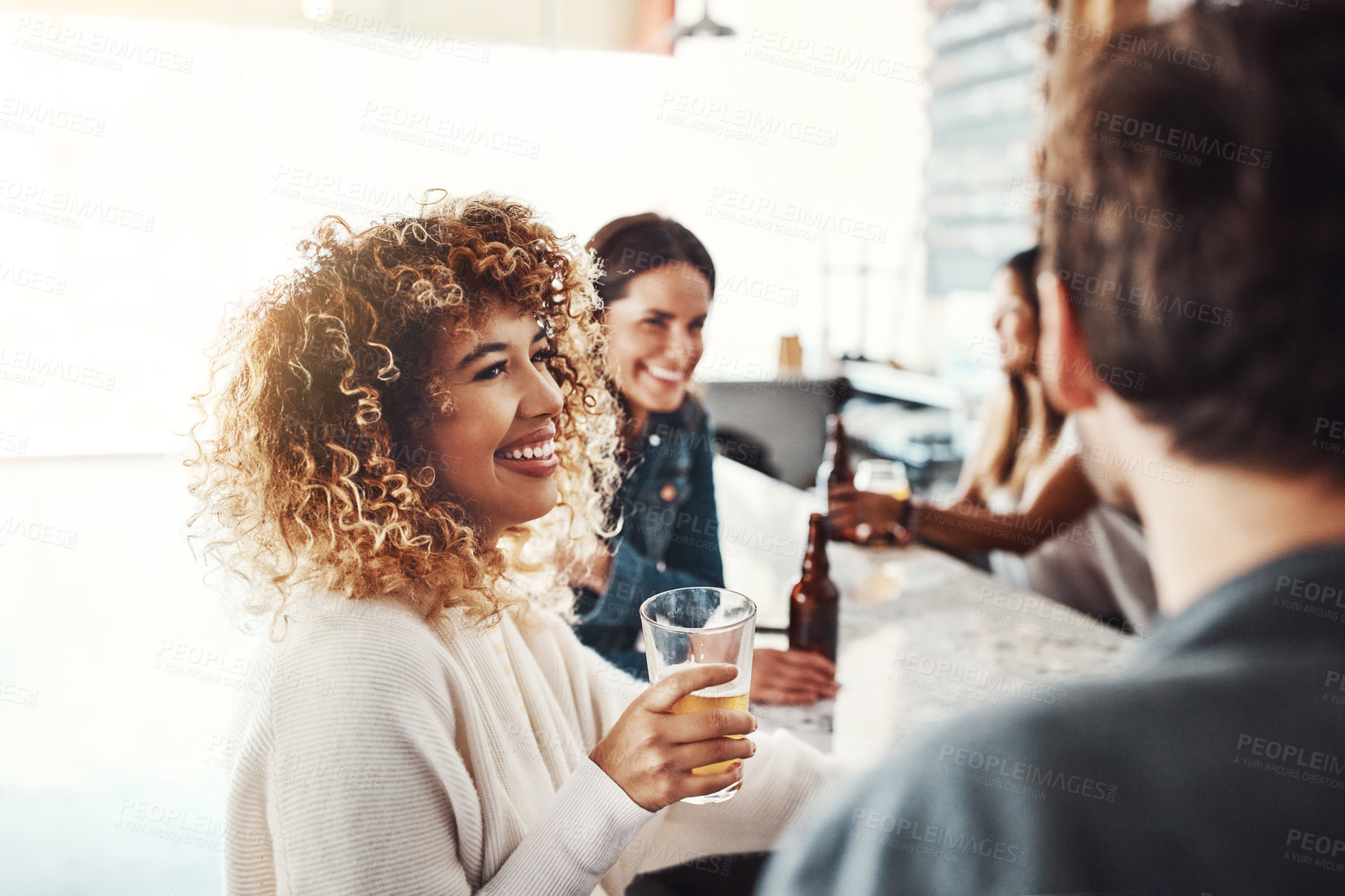 Buy stock photo Shot of a group of friends enjoying some beers at a bar