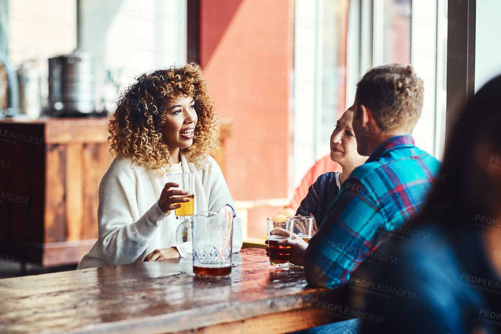 Buy stock photo Shot of a group of friends enjoying some beers at a bar