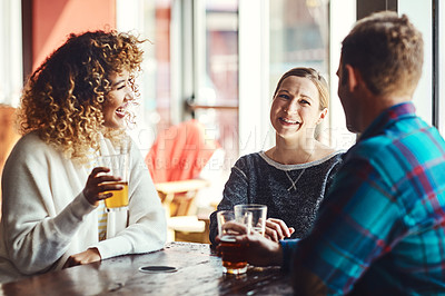 Buy stock photo Shot of a group of friends enjoying some beers at a bar