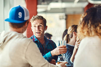 Buy stock photo Shot of a group of friends enjoying some beers at a bar