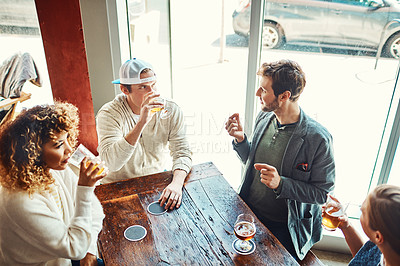 Buy stock photo Shot of a group of friends enjoying some beers at a bar