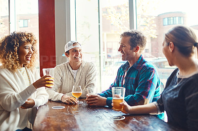 Buy stock photo Shot of a group of friends enjoying some beers at a bar