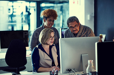 Buy stock photo Shot of a group of businesspeople working late in an office