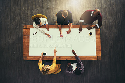 Buy stock photo High angle shot of a group of businesspeople having a meeting with the word “teamwork” superimposed over them