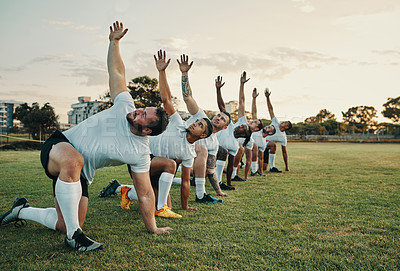 Buy stock photo Full length shot of a group of young rugby players training on the field during the day