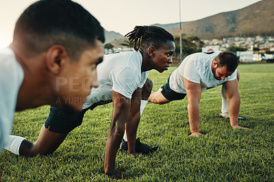 Buy stock photo Cropped shot of a group of young rugby players training on the field during the day