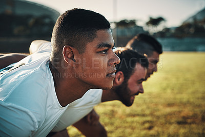 Buy stock photo Cropped shot of a group of three young rugby players lining up for a scrum on the field during the day